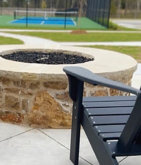 Black chair facing a fire pit