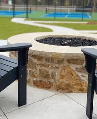 Black chairs facing a fire pit